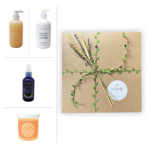 Earthsavers Spa Gift Box wrapped with green leaf ribbon and topped with lavender and wheat. Yellow colored Circulate Bath & Shower Gel, White colored Prevent Lotion, Circulate Aromatherapy Mist in a blue, glass bottle, and Citrus Salt Glow scrub in a clear and orange colored jar are pictured to the left of the box.